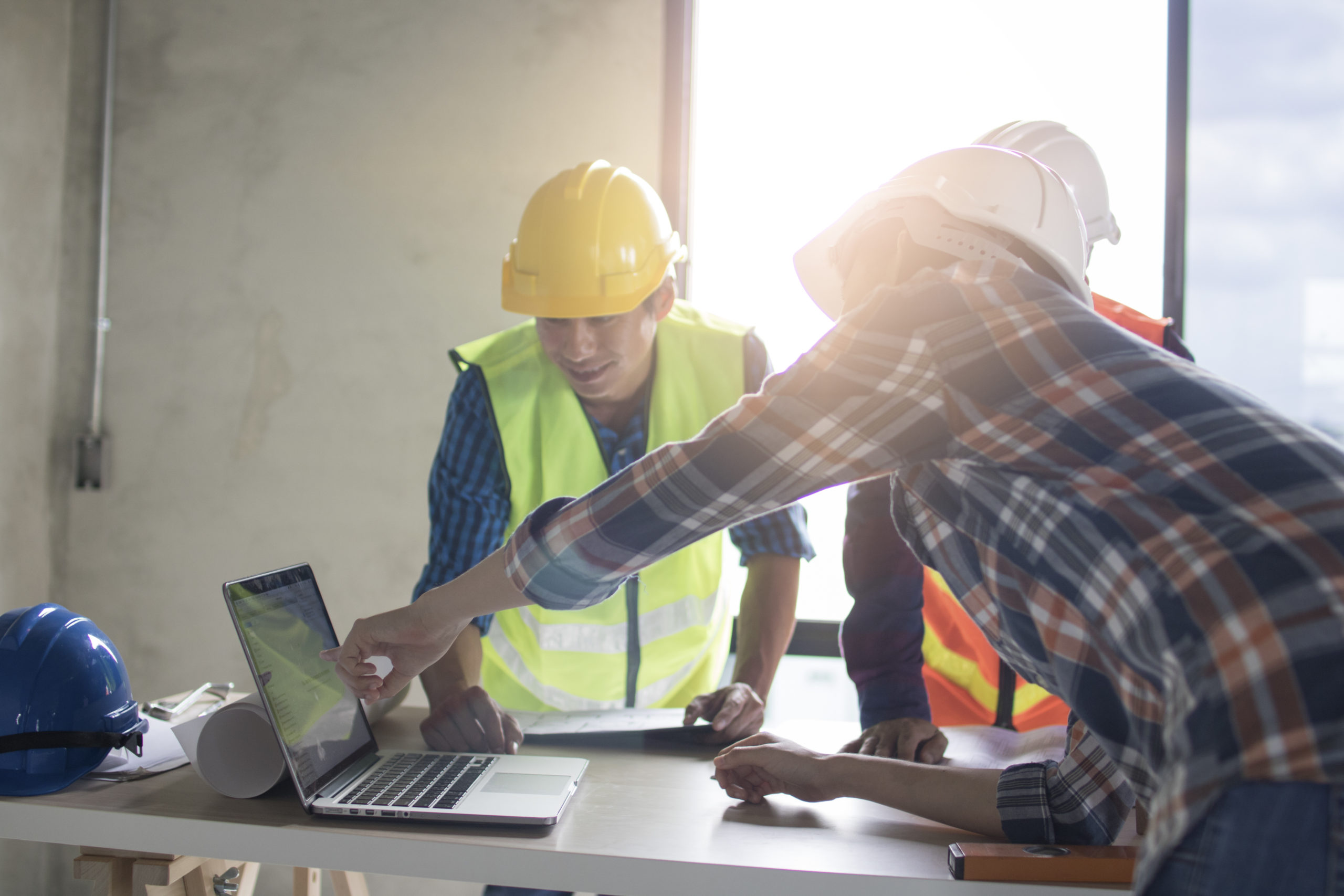 engineer team planning and discussing about construction building on table in working site